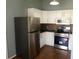 Modern kitchen with stainless steel appliances, white cabinets, and stone backsplash at 8750 Se 88Th Ave, Ocala, FL 34472
