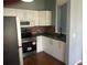 Well-equipped kitchen featuring stainless steel appliances, white cabinets, and modern fixtures at 8750 Se 88Th Ave, Ocala, FL 34472