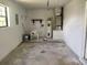 Utility room with water heater and extra space at 8750 Se 88Th Ave, Ocala, FL 34472
