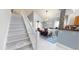 Bright dining area adjacent to the staircase with decorative rug and pendant lighting at 101 Grand Junction Blvd, Orlando, FL 32835