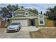 Charming two-story home with a well-maintained lawn, a driveway with a car, and a welcoming blue front door at 101 Grand Junction Blvd, Orlando, FL 32835
