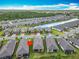 Community aerial view with water views and home indicated by a red arrow at 1029 Umbria Dr, Poinciana, FL 34759