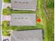 Aerial view showcasing the property's roof, landscaping, and proximity to neighboring homes at 1029 Umbria Dr, Poinciana, FL 34759