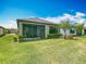 A well-maintained backyard featuring lush green grass, a screened lanai, and neat landscaping at 1029 Umbria Dr, Poinciana, FL 34759