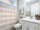 Clean bathroom features a single sink and a shower with a curtain at 1029 Umbria Dr, Poinciana, FL 34759