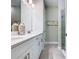 Bright bathroom with double sinks, white cabinetry, and glass-enclosed shower at 1029 Umbria Dr, Poinciana, FL 34759