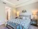 Comfortable bedroom features nautical-themed decor and a connecting door to bath at 1029 Umbria Dr, Poinciana, FL 34759