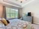 Charming bedroom featuring a ceiling fan and a large window overlooking a green space at 1029 Umbria Dr, Poinciana, FL 34759