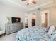 Beautiful bedroom features a tray ceiling, ceiling fan, and walk-in closet at 1029 Umbria Dr, Poinciana, FL 34759