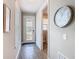 Bright foyer with wood-look tile flooring, a decorative clock, and a door with decorative glass at 1029 Umbria Dr, Poinciana, FL 34759