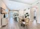 Open kitchen with a round dining table, white cabinetry, and stainless appliances at 1029 Umbria Dr, Poinciana, FL 34759