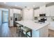 Open-concept kitchen with a large island, white cabinets, and stainless steel appliances flowing into the home's entryway at 1029 Umbria Dr, Poinciana, FL 34759