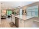 Spacious kitchen with a white quartz island overlooking the living room, perfect for entertaining and modern living at 1029 Umbria Dr, Poinciana, FL 34759