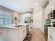 Bright, spacious kitchen with a large island, stainless steel appliances, and modern white cabinetry at 1029 Umbria Dr, Poinciana, FL 34759