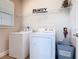 Bright laundry room featuring a washer and dryer set and wire shelving for storage at 1029 Umbria Dr, Poinciana, FL 34759