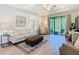 Bright living room with tile floors, neutral colors and sliding doors to screened porch at 1029 Umbria Dr, Poinciana, FL 34759