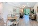 Open floor plan featuring a living room and dining area with wood-look floors and plenty of natural light at 1029 Umbria Dr, Poinciana, FL 34759