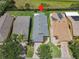An aerial view of a well-maintained home featuring a gray roof and a brick driveway at 112 Grand Canal Dr, Poinciana, FL 34759