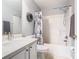 Bathroom with white marble countertop, shower and stylish design features at 112 Grand Canal Dr, Poinciana, FL 34759