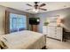 Bedroom with neutral walls, large window, ceiling fan, and furniture for a calming retreat at 112 Grand Canal Dr, Poinciana, FL 34759