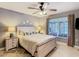 Charming bedroom featuring a large window, ceiling fan, and a comfortable queen size bed at 112 Grand Canal Dr, Poinciana, FL 34759