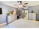 Bedroom with neutral walls, large window, ceiling fan, and furniture for a calming retreat at 112 Grand Canal Dr, Poinciana, FL 34759