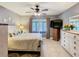 Bedroom with neutral walls, large window, ceiling fan, and furniture for a calming retreat at 112 Grand Canal Dr, Poinciana, FL 34759