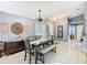 Open dining room features stylish decor, a modern chandelier, and plenty of natural light at 112 Grand Canal Dr, Poinciana, FL 34759
