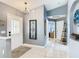 Bright entryway features neutral walls, tiled floors, stylish lighting, and decorative wall art at 112 Grand Canal Dr, Poinciana, FL 34759