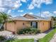Exterior view showcasing the home's architecture, landscaping, and brick paved walkway at 112 Grand Canal Dr, Poinciana, FL 34759