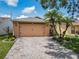 Beautiful landscaping complements the home's exterior, along with a brick paved driveway for added appeal at 112 Grand Canal Dr, Poinciana, FL 34759
