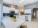 Contemporary kitchen featuring white cabinets, tile floors, stainless steel appliances, a breakfast table and chairs at 112 Grand Canal Dr, Poinciana, FL 34759