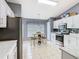 Bright kitchen with white cabinets, modern appliances, tile floors, and a cozy breakfast nook with natural light at 112 Grand Canal Dr, Poinciana, FL 34759