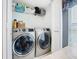 Laundry room with front load washer and dryer with a shelf above and wood countertop at 112 Grand Canal Dr, Poinciana, FL 34759