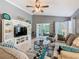 Bright living room with vaulted ceiling includes neutral colors, comfortable furnishings, and lanai access at 112 Grand Canal Dr, Poinciana, FL 34759