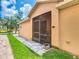Relaxing screened patio offers an outdoor living space with views of the green backyard at 112 Grand Canal Dr, Poinciana, FL 34759