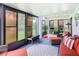 Inviting sunroom with wicker furniture and sliding glass doors to the backyard at 112 Grand Canal Dr, Poinciana, FL 34759