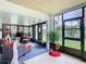Cozy sunroom with wicker furniture, lots of windows, and a view of the backyard at 112 Grand Canal Dr, Poinciana, FL 34759