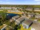 An aerial view of the neighborhood highlighting surrounding trees and a pond at 1251 Ash Tree Cv, Casselberry, FL 32707