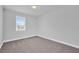 Bright bedroom featuring a window, soft carpeting, and neutral walls at 1251 Ash Tree Cv, Casselberry, FL 32707