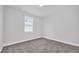 Cozy bedroom with a bright window, soft carpeting, and neutral walls at 1251 Ash Tree Cv, Casselberry, FL 32707