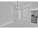 Dining area featuring stainless steel appliances, modern lighting fixture, and convenient access to the kitchen at 1251 Ash Tree Cv, Casselberry, FL 32707