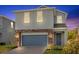 Charming two-story home with a blue garage door, brick accents, and a well-maintained front lawn at 1251 Ash Tree Cv, Casselberry, FL 32707