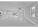 Bright living space featuring sleek tile floors, a ceiling fan, and seamless transition to the kitchen area at 1251 Ash Tree Cv, Casselberry, FL 32707