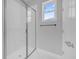 Stylish walk-in shower enclosure with seamless glass doors and marble walls at 1251 Ash Tree Cv, Casselberry, FL 32707