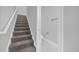 Stairway leading upstairs alongside half bath featuring modern fixtures and tile flooring at 1251 Ash Tree Cv, Casselberry, FL 32707