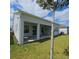 Covered patio and large backyard with well-manicured lawn at 19235 Allium Pl, Orlando, FL 32827