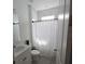 Bright bathroom features a shower with marble-look tiling and updated fixtures at 19235 Allium Pl, Orlando, FL 32827