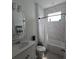 Bright bathroom featuring a shower-tub combo with marble-look tile and a white vanity at 19235 Allium Pl, Orlando, FL 32827