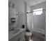 Bright bathroom featuring a shower-tub combo with marble-look tile and a white vanity at 19235 Allium Pl, Orlando, FL 32827